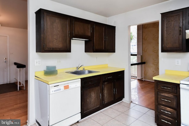 kitchen featuring light hardwood / wood-style floors, dark brown cabinetry, white appliances, and sink