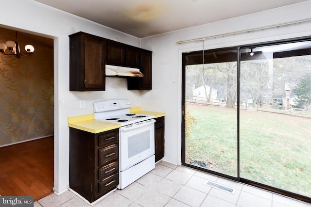 kitchen with white range with electric cooktop, dark brown cabinetry, and light tile patterned floors