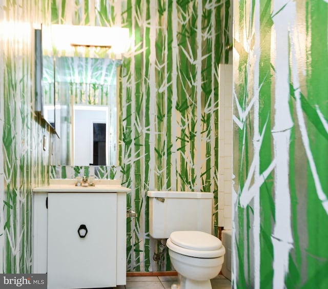 bathroom featuring tile patterned floors, vanity, and toilet