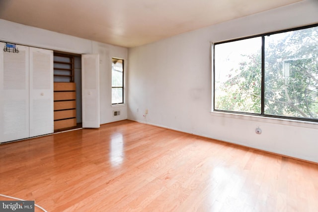 unfurnished bedroom with light hardwood / wood-style floors and a closet