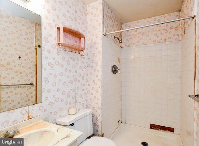 bathroom featuring toilet and tiled shower