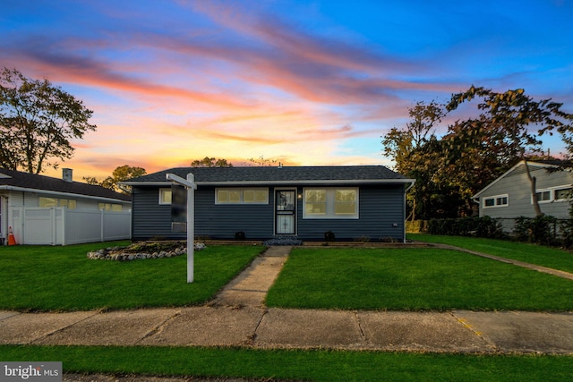 ranch-style home featuring a yard