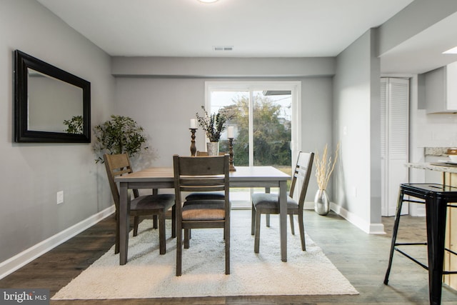 dining space with dark wood-type flooring