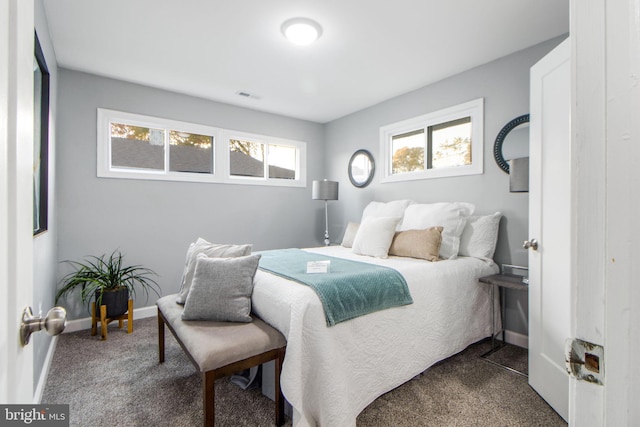 carpeted bedroom featuring multiple windows