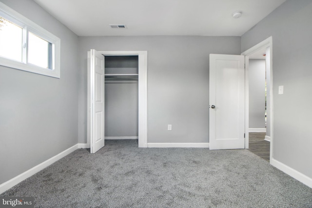 unfurnished bedroom with carpet floors and a closet