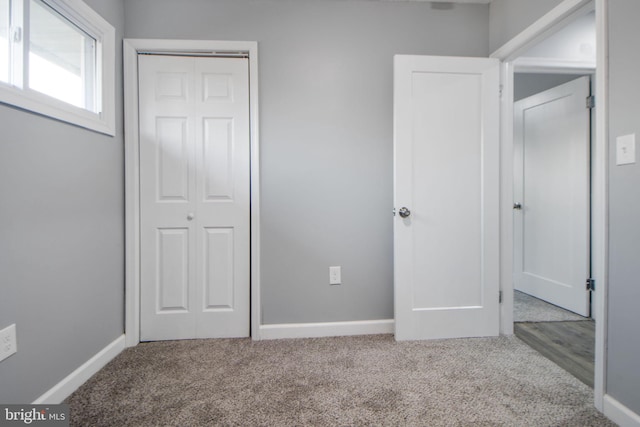 unfurnished bedroom featuring a closet and carpet flooring