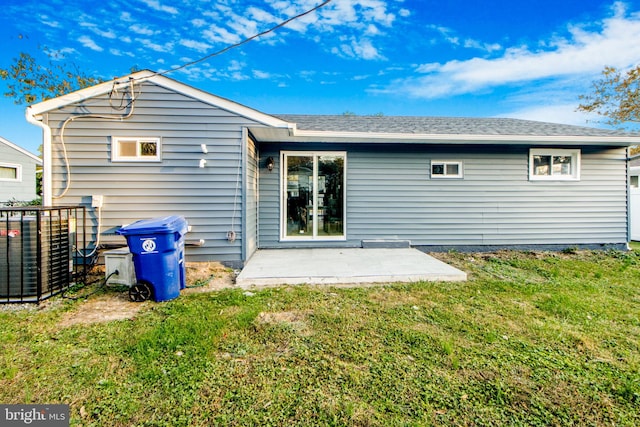 rear view of house featuring a patio area and a lawn