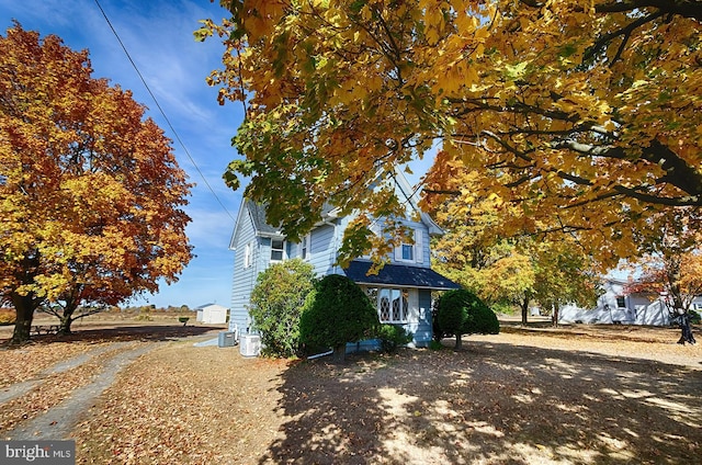 view of side of property featuring central AC