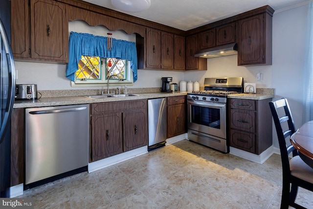 kitchen featuring dark brown cabinets, appliances with stainless steel finishes, and sink