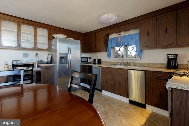 kitchen featuring dark brown cabinetry, appliances with stainless steel finishes, and sink