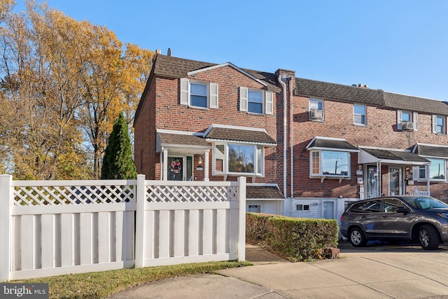 view of front of property with a garage and cooling unit