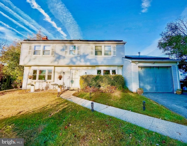 view of front of house with a garage and a front yard