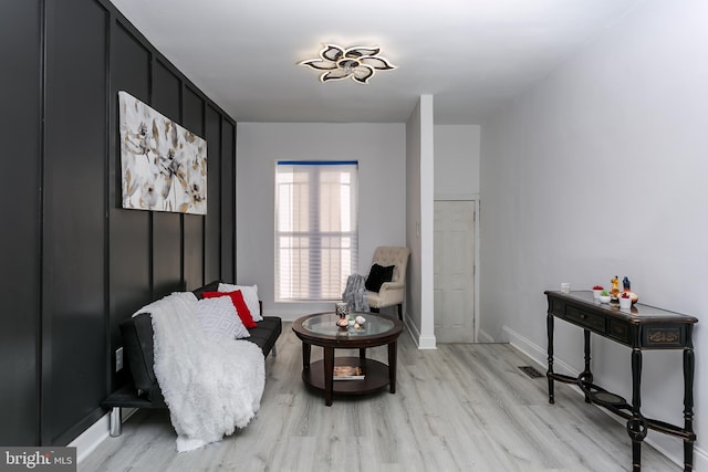 sitting room featuring light hardwood / wood-style floors