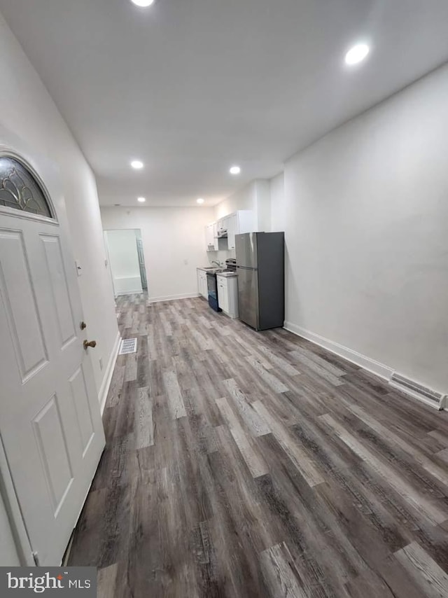 unfurnished living room featuring dark hardwood / wood-style floors