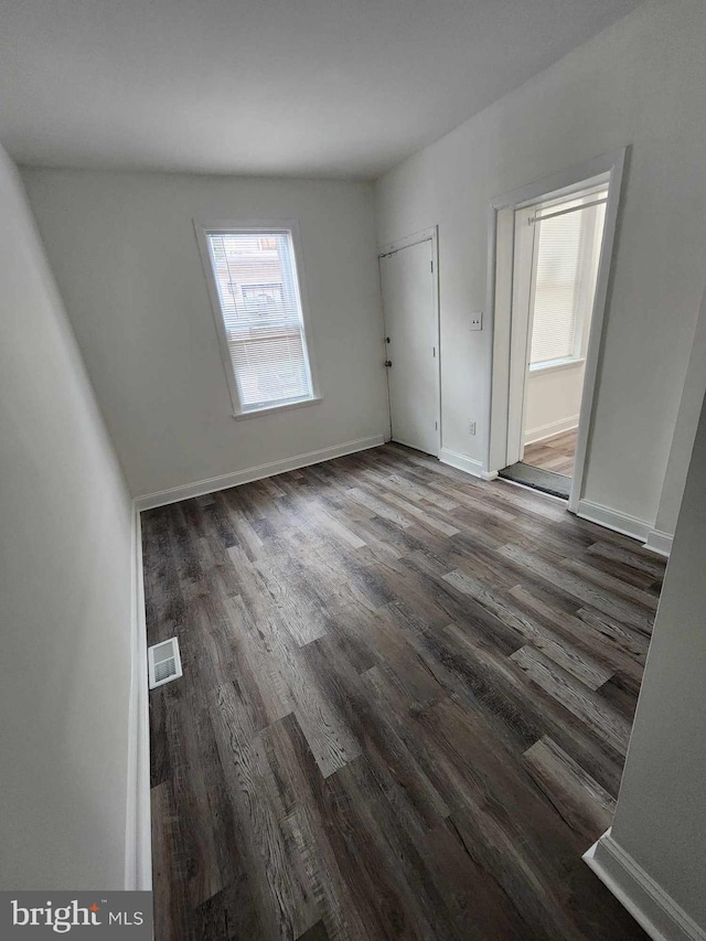 spare room with dark hardwood / wood-style floors