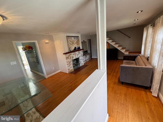 living room with wood-type flooring and a fireplace