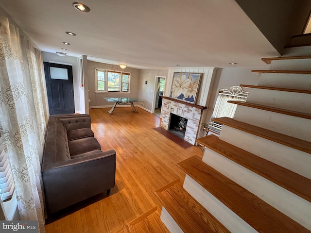 unfurnished living room featuring wood-type flooring and a fireplace