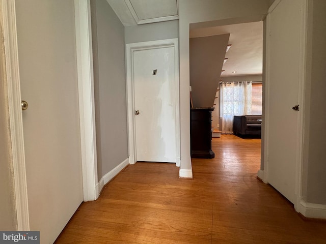 corridor with light hardwood / wood-style floors