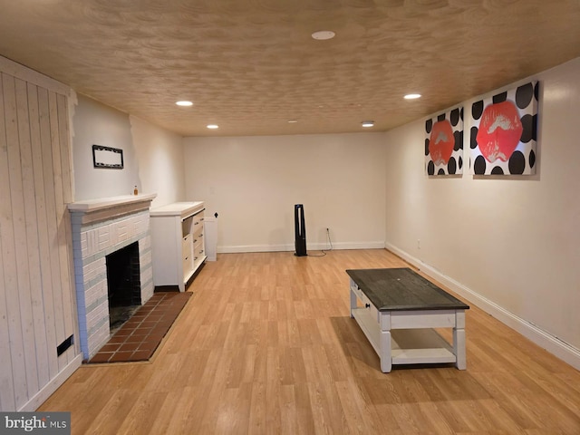 interior space featuring wood walls, light wood-type flooring, and a fireplace