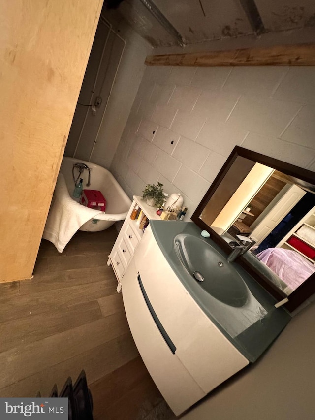 bathroom featuring a tub to relax in and vanity