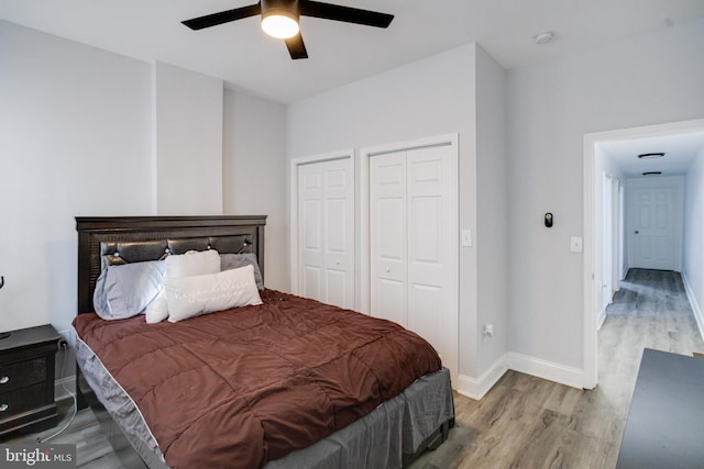 1107 S Carey St, Baltimore, MD 21223 - bedroom with wood finished floors, two closets, baseboards, and a ceiling fan