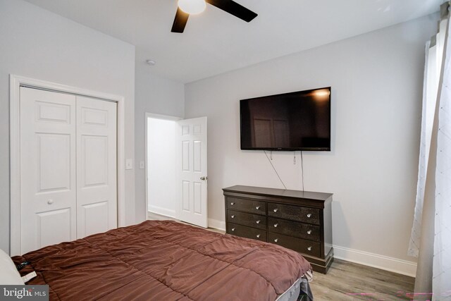 1107 S Carey St, Baltimore, MD 21223 - bedroom with a closet, baseboards, wood finished floors, and a ceiling fan