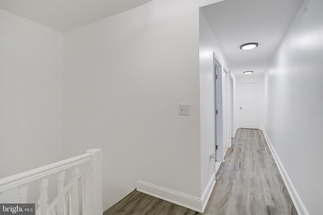 1107 S Carey St, Baltimore, MD 21223 - hall with an upstairs landing, wood finished floors, and baseboards