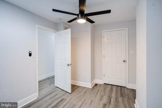 1107 S Carey St, Baltimore, MD 21223 - unfurnished bedroom with wood finished floors, baseboards, and a ceiling fan
