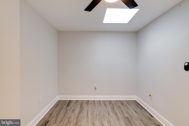 1107 S Carey St, Baltimore, MD 21223 - spare room featuring a skylight, a ceiling fan, wood finished floors, and baseboards