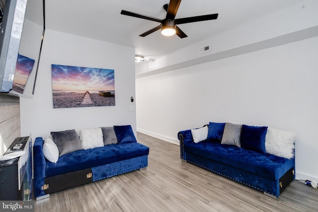 1107 S Carey St, Baltimore, MD 21223 - living area featuring wood finished floors, ceiling fan, and baseboards