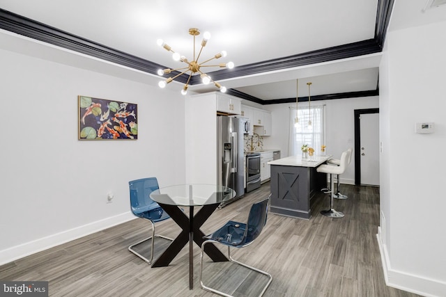 1107 S Carey St, Baltimore, MD 21223 - dining area featuring a chandelier, light wood finished floors, baseboards, and ornamental molding