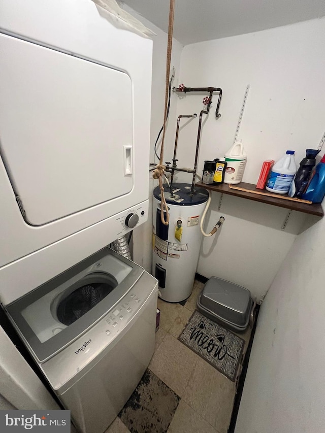 washroom featuring water heater and stacked washer and dryer