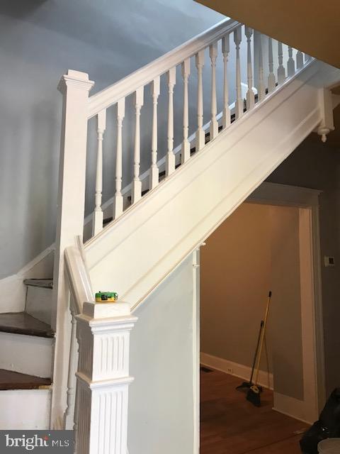 stairs featuring hardwood / wood-style floors