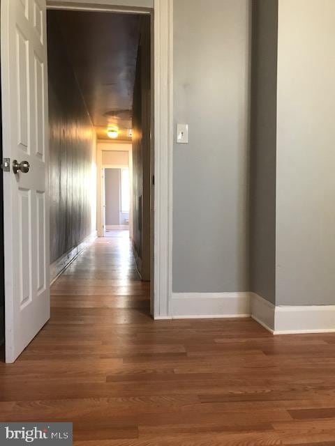 corridor with hardwood / wood-style floors