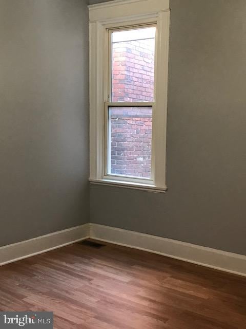 unfurnished room featuring hardwood / wood-style floors