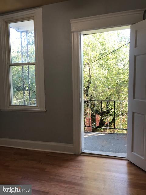 doorway with hardwood / wood-style flooring