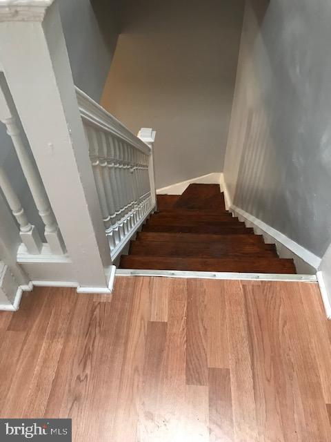 stairway featuring hardwood / wood-style flooring