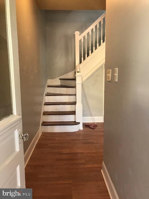 stairway featuring hardwood / wood-style floors