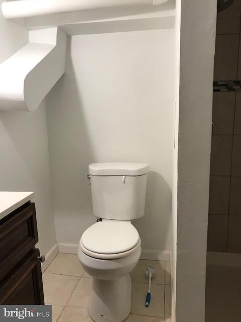 bathroom featuring vanity, toilet, and tile patterned flooring