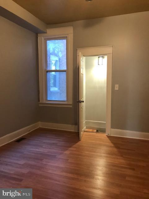 empty room with dark wood-type flooring