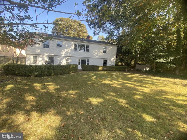 rear view of house with a yard