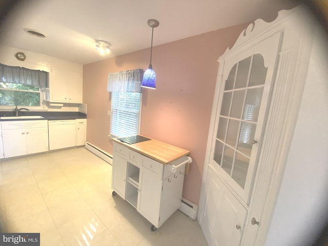 kitchen with white dishwasher, white cabinetry, and plenty of natural light