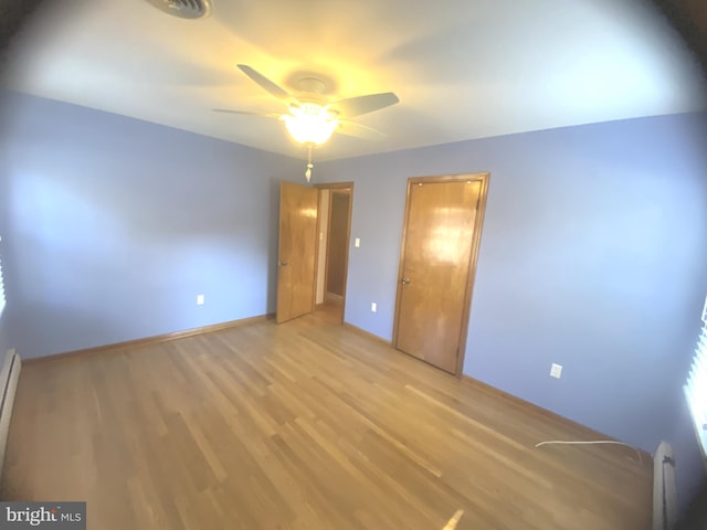 unfurnished bedroom with light hardwood / wood-style floors and ceiling fan