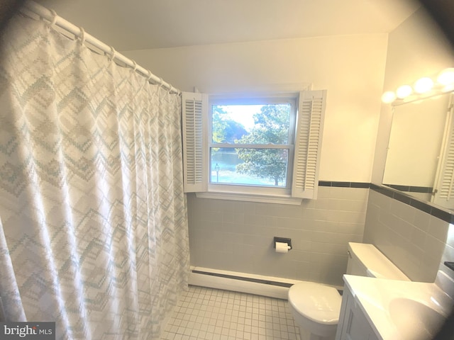 bathroom featuring a baseboard radiator, tile walls, toilet, vanity, and tile patterned floors