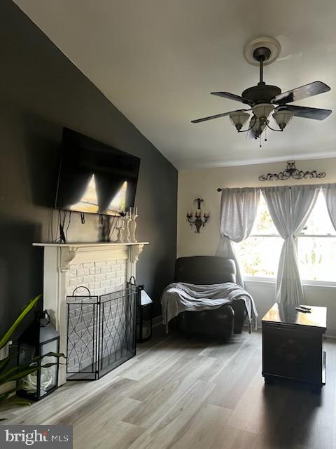 living area with hardwood / wood-style floors and ceiling fan