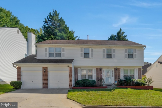 view of front of home with a front lawn and a garage