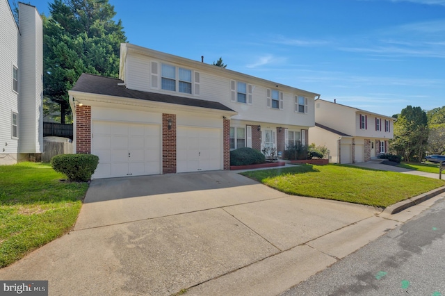 view of front of property featuring a front yard and a garage