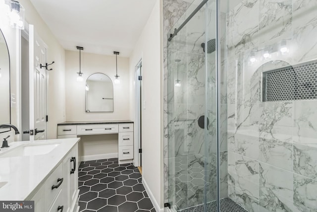 bathroom featuring tile patterned flooring, vanity, and a shower with shower door