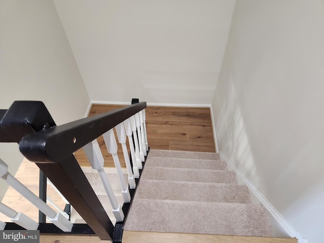 stairs featuring wood-type flooring