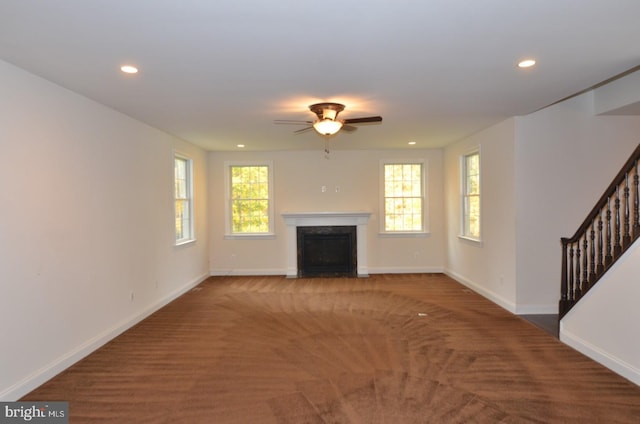 unfurnished living room with carpet floors and ceiling fan